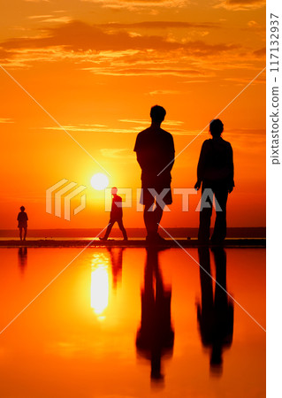 Silhouettes of people against sky seascape sunset sky on sea or ocean 117132937