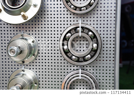 different bearings on a metal background. Part of mechanism. different bearings on a metal background. Part of mechanism. 117134411