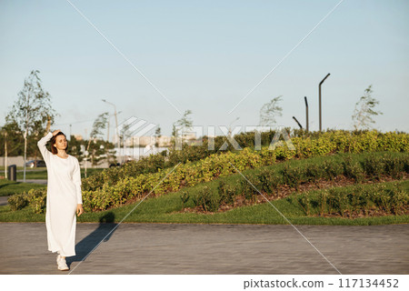 Woman crossing the road at a crosswalk Woman crossing the road at a crosswalk 117134452