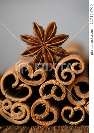 Macro shot of anise star and heap of cinnamon sticks close up Macro shot of anise star and heap of cinnamon sticks close up 117134709