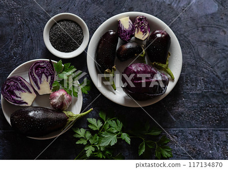 Purple vegetables arranged on a dark table 117134870