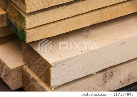 Stacked rough boards closeup photo with selective focus Stacked rough boards closeup photo with selective focus 117134942