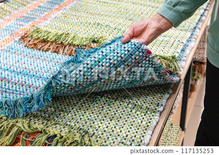 A woven rug made of old things. Eco-friendly development. Reuse of items. Handmade work. 117135253