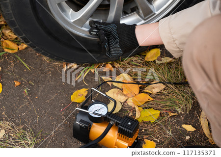 Man car inspection Measure quantity Inflated Rubber tires car.Close up hand holding machine Inflated pressure gauge for car tyre pressure measurement for automotive, automobile image Man car inspection Measure quantity Inflated Rubber tires car.Close up hand holding machine Inflated pressure gauge for car tyre pressure measurement for automotive, automobile image 117135371