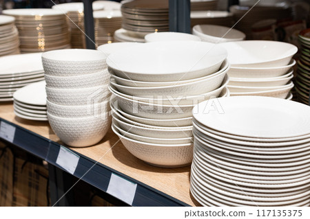 Different clean plates in dish drying rack on kitchen counter Different clean plates in dish drying rack on kitchen counter 117135375