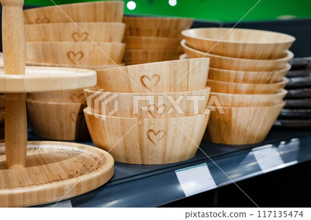 Wooden breakfast tray on the shelf in the store. Environmental friendliness. Reuse. Handmade work. Wooden breakfast tray on the shelf in the store. Environmental friendliness. Reuse. Handmade work. 117135474