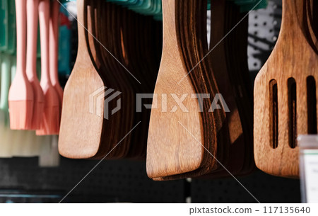 Various kitchen utensils made of wood in the stand. Copy the place for the close-up text. Environmental friendliness. Reuse. Handmade work. Various kitchen utensils made of wood in the stand. Copy the place for the close-up text. Environmental friendliness. Reuse. Handmade work. 117135640