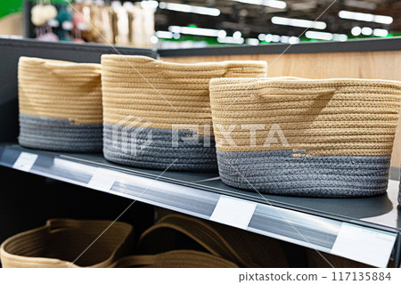 A wicker basket in the store made of ecological materials. Reuse of items. Handmade work. 117135884