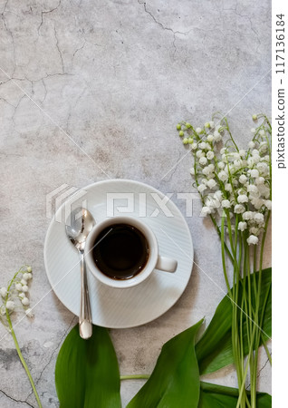 Lily of the valley flowers in glass vase, black background, selective focus 117136184