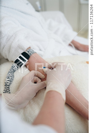 Medical Professional Administers Injection to Patient in Hospital During Afternoon Appointment 117136264