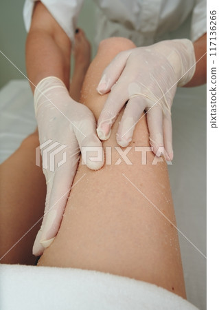 Professional Massage Therapy Session Focused on Relaxation and Pain Relief at a Spa 117136266