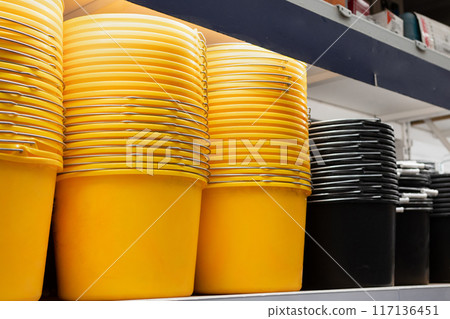 colorful plastic basins and buckets on the counter in a supermarket colorful plastic basins and buckets on the counter in a supermarket 117136451