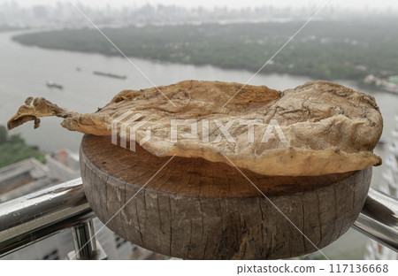 Fish Maw Soup or Dried Fish Stomach on Old wooden cutting board. Fish Maw Soup or Dried Fish Stomach on Old wooden cutting board. 117136668