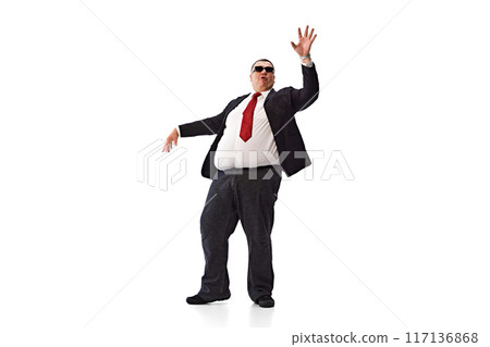 Confident man, businessman in formal wear, black suit and sunglasses, dancing isolated on white background. Positive attitude at work 117136868