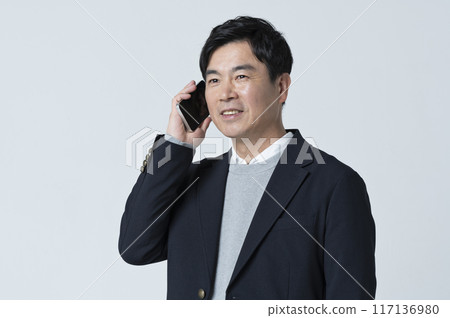 A man in his 50s making a phone call 117136980