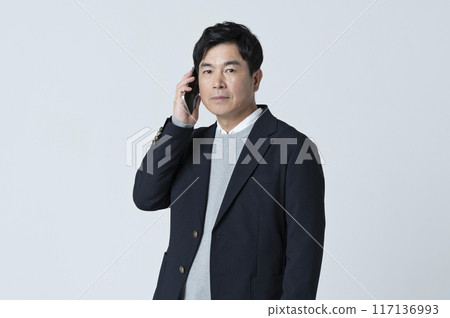 A man in his 50s making a phone call A man in his 50s making a phone call 117136993