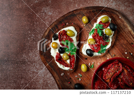 sandwich with cream cheese, dried tomatoes, olives, breakfast, top view, 117137210