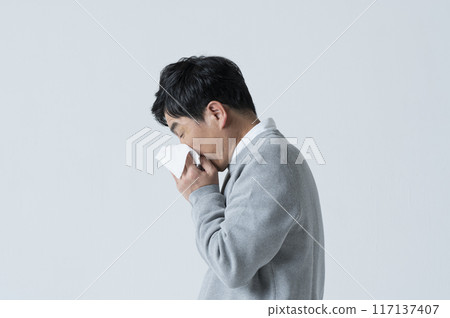 A man in his 50s blowing his nose 117137407