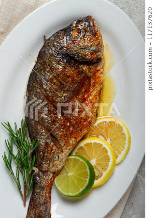 baked dorado fish, in the oven, fried dorado, with spices and herbs, on a white plate, top view, homemade, no people, baked dorado fish, in the oven, fried dorado, with spices and herbs, on a white plate, top view, homemade, no people, 117137620