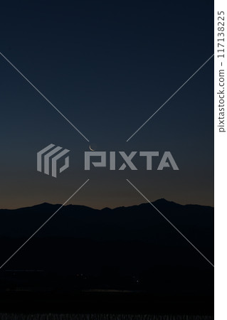 A thin, 28.0 day old moon over the Okuchichibu mountain range seen from Hakushu Town, Hokuto City A thin, 28.0 day old moon over the Okuchichibu mountain range seen from Hakushu Town, Hokuto City 117138225