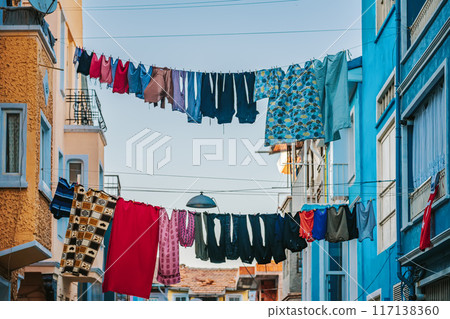 Colorful Laundry Hanging Above A Vibrant Street In Coastal Town Colorful Laundry Hanging Above A Vibrant Street In Coastal Town 117138360