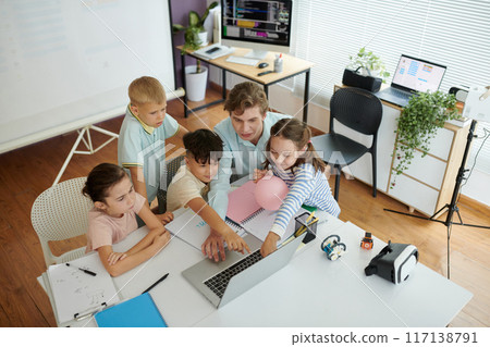 Teacher Engaging Children in Interactive Technology Lesson 117138791