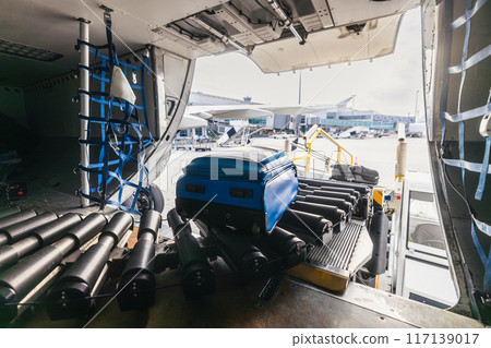 Loading of luggage to airplane at airport. Loading of luggage to airplane at airport. 117139017