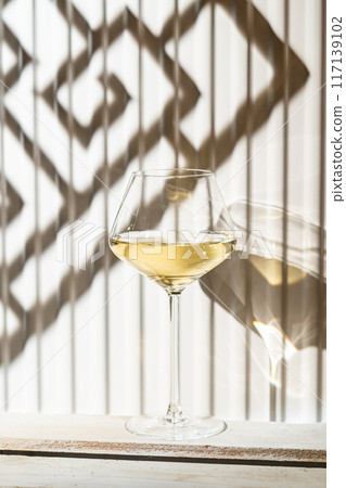 A glass of white wine A glass of white wine 117139102