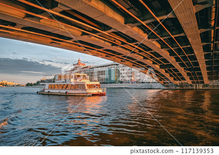 Dramatic view of the Moskva River. White tourist launch at sunset. 117139353