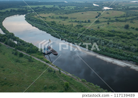 The process of cleaning the river from pollution. Barge and river crane working on the river 117139489