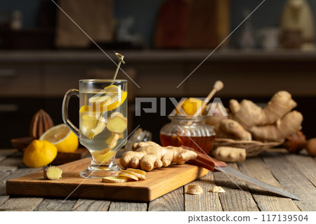 Ginger tea with lemon and honey on an old wooden table. Ginger tea with lemon and honey on an old wooden table. 117139504
