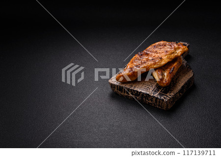 Delicious fresh grilled chicken fillet with spices and herbs Delicious fresh grilled chicken fillet with spices and herbs 117139711