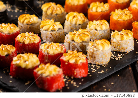 Japanese salmon sushi with spicy mayonnaise and tobiko caviar - Sushi menu norimaki and uramaki. Asian cuisine concept 117140688