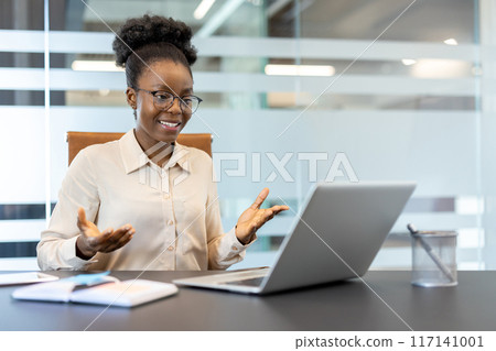 Professional businesswoman communicating effectively through video call. Confident office worker using technology for virtual meeting, exhibiting professionalism and work engagement in workspace. 117141001