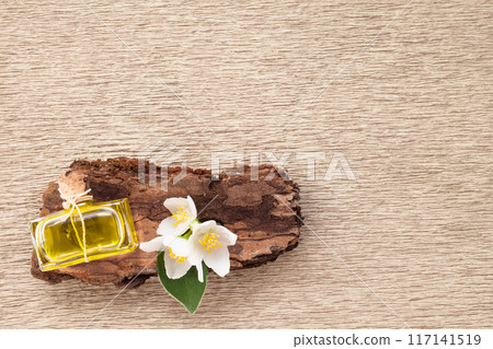 Jasmine flowers, bark and perfume bottle on white background. Flat lay. Copy space 117141519