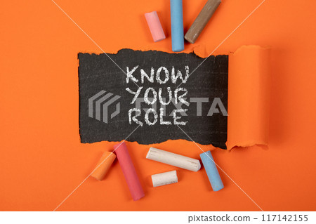 Know your Role. Text under torn orange paper on a blackboard 117142155