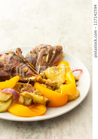 Enjoy a hearty breakfast or lunch with baked turkey served alongside roasted zucchini, sweet peppers, and onions 117142594