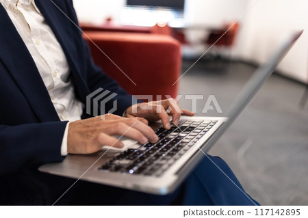 Unrecognizable woman employee working on laptop typing on keyboard Unrecognizable woman employee working on laptop typing on keyboard 117142895