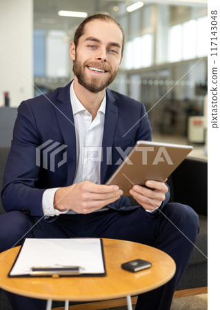Businessman working on digital tablet at the office of car showroom 117143048