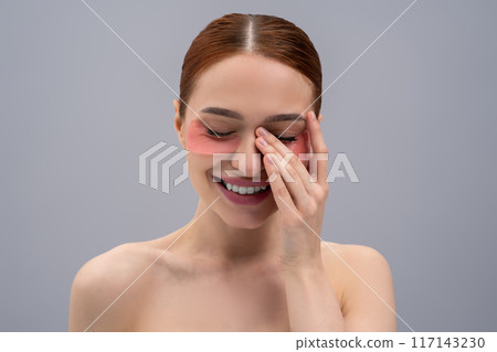 Portrait of a pretty young woman with moisturizing patches under her eyes Portrait of a pretty young woman with moisturizing patches under her eyes 117143230