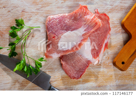 Raw slice of Iberian pork secret and parsley 117146177