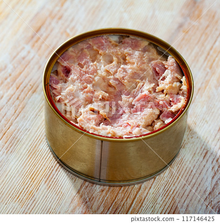 Tin can with ham on a wooden surface 117146425