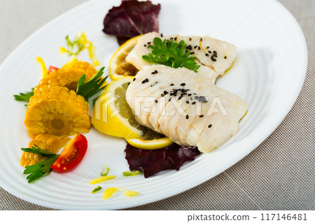 Codfish prepared on steam , served with boiled corn, herbs and lemon Codfish prepared on steam , served with boiled corn, herbs and lemon 117146481