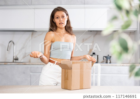 Woman inspects package 117146691