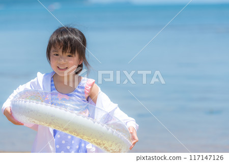 A girl swimming in the sea during summer vacation 117147126