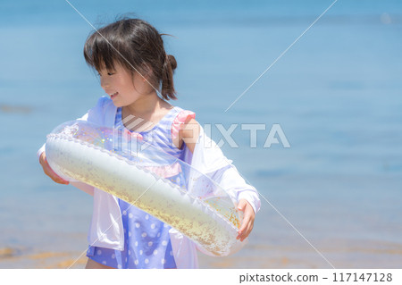 A girl swimming in the sea during summer vacation A girl swimming in the sea during summer vacation 117147128