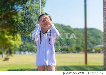 Girl taking outdoor shower at beach Girl taking outdoor shower at beach 117147147