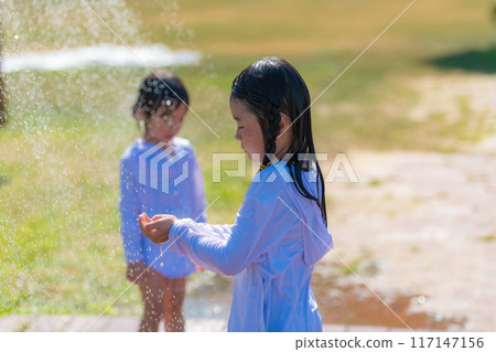 Girl taking outdoor shower at beach 117147156