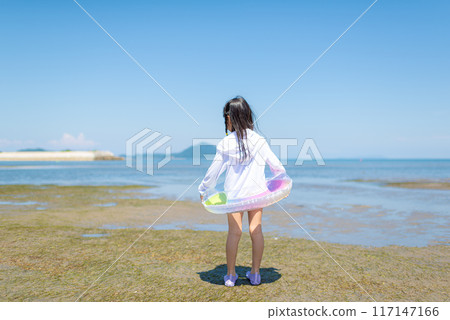 A girl swimming in the sea during summer vacation A girl swimming in the sea during summer vacation 117147166