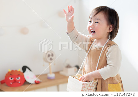 Infant (1 year old) enjoying bean-throwing Infant (1 year old) enjoying bean-throwing 117147278